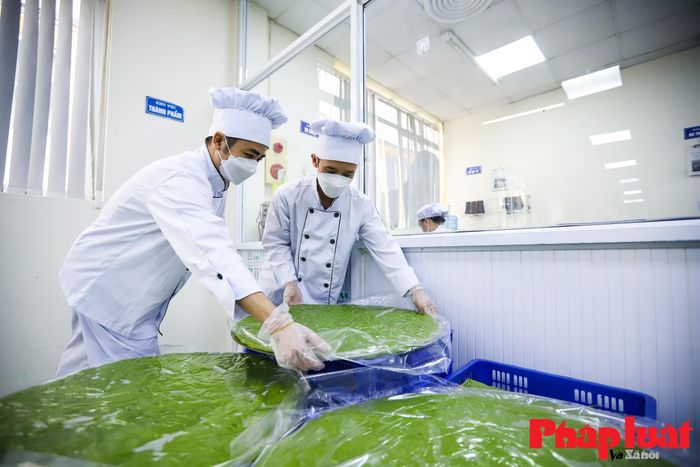 Những lớp vỏ bánh và nhân đậu xanh vừa được dàn xong sẽ đặt riêng trên từng lớp giấy bóng kính để chống dính.